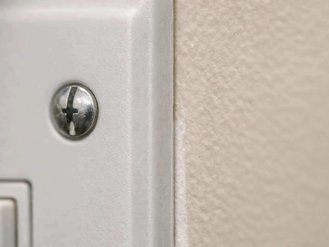 Open ceiling access panel showing boxed ventilation duct above a white hallway